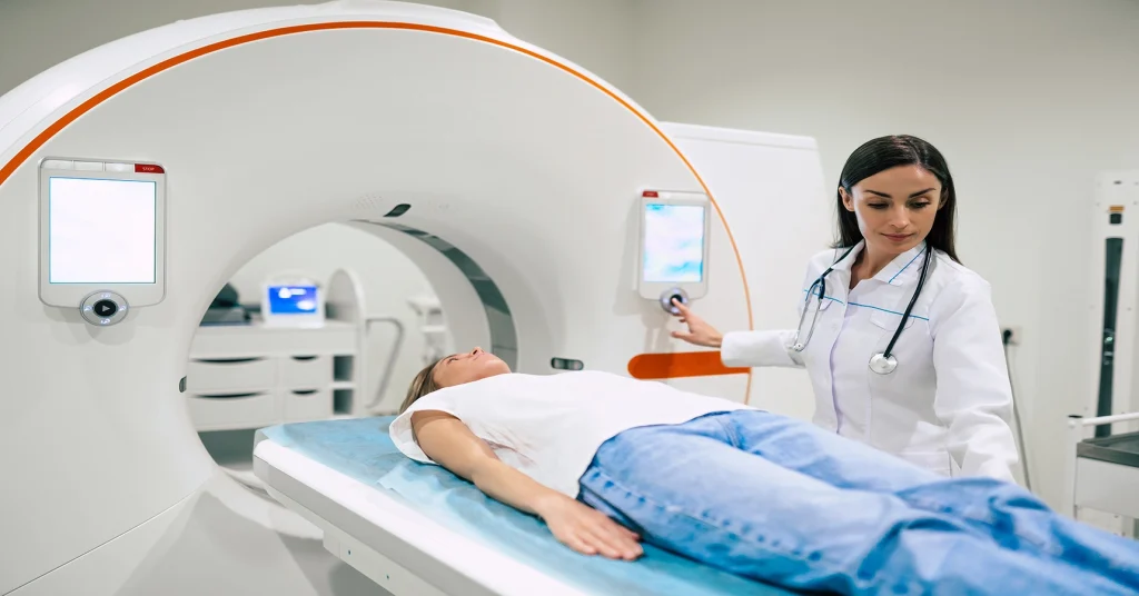 Young Female Technologist Operates CT Scan For Female Patient