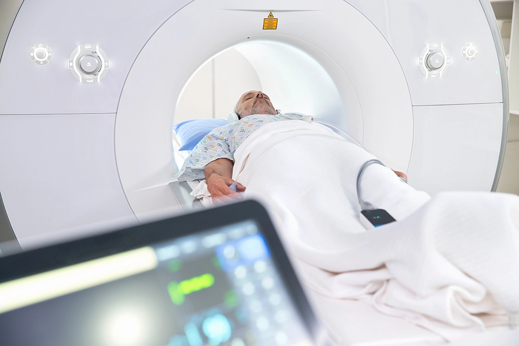 Male Patient Listening To Music While Undergoing MRI Scan