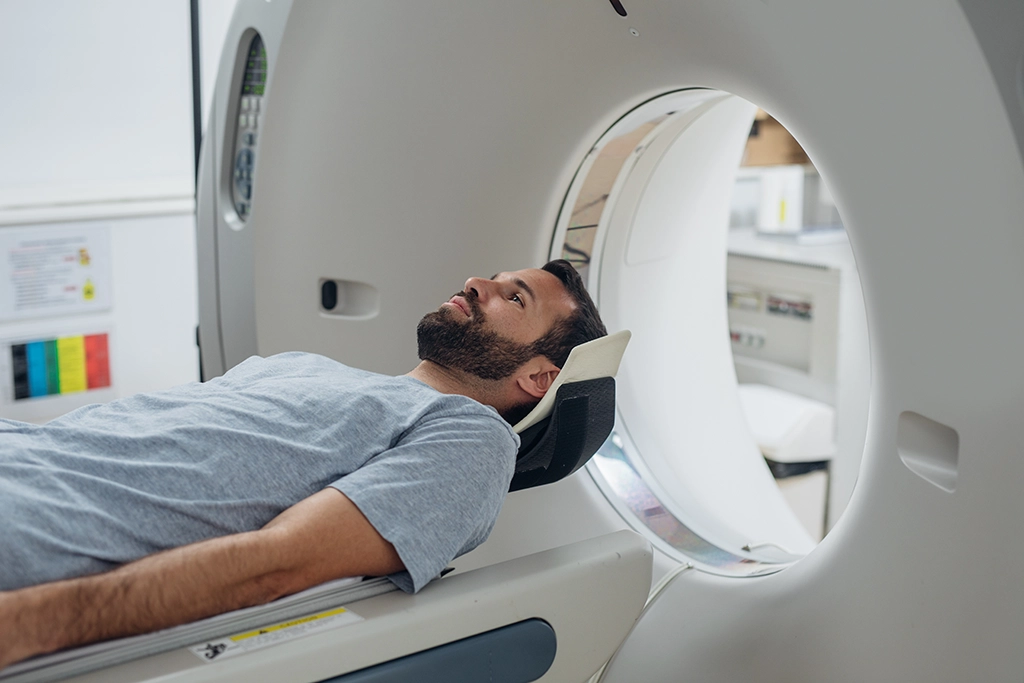 Male Patient Undergoes A CT Scan In A Comfortable Room