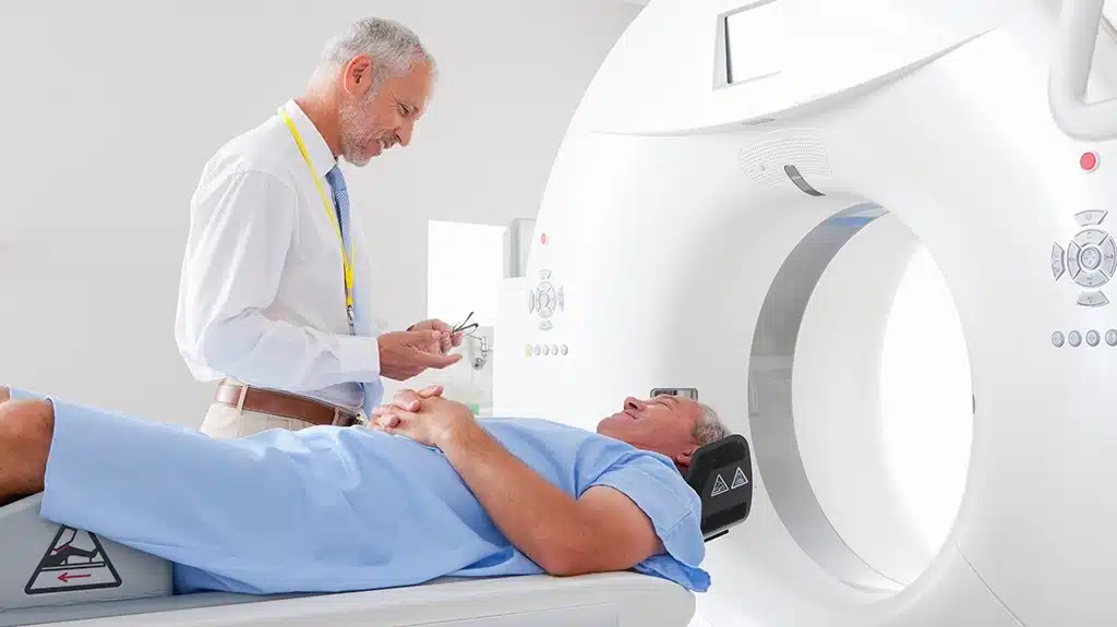 CT Technologists Speaking With Male Patient Before CT Scan